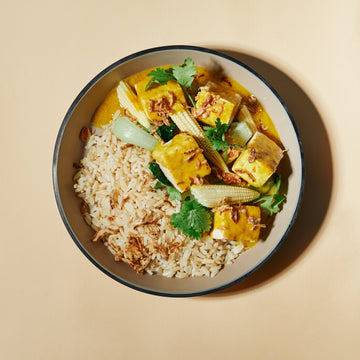 Tempeh Light Coconut Yellow Curry with Lime Leaf, Fried Shallots, Steamed Greens, Baby Corn & Steamed Thai Red Rice