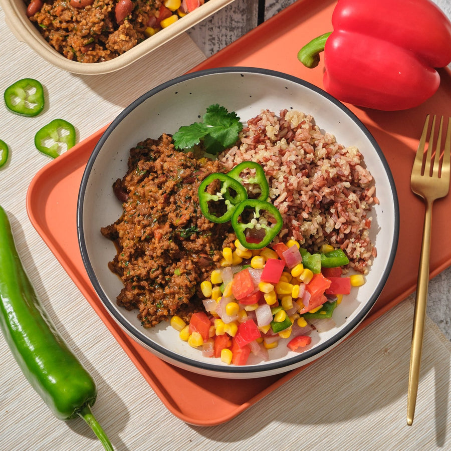 Plant-Based Pork Chilli with Charred Corn, Roasted Peppers, Tomatoes, Cheddar Cheese & Steamed Thai Red Rice & Quinoa