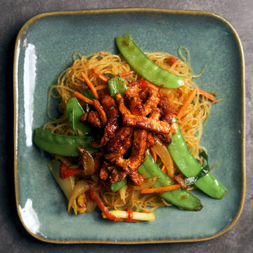Singapore Style Curried Noodles with Char Siu OmniPork Strips, Snow Peas, Red Peppers & Shredded Carrots