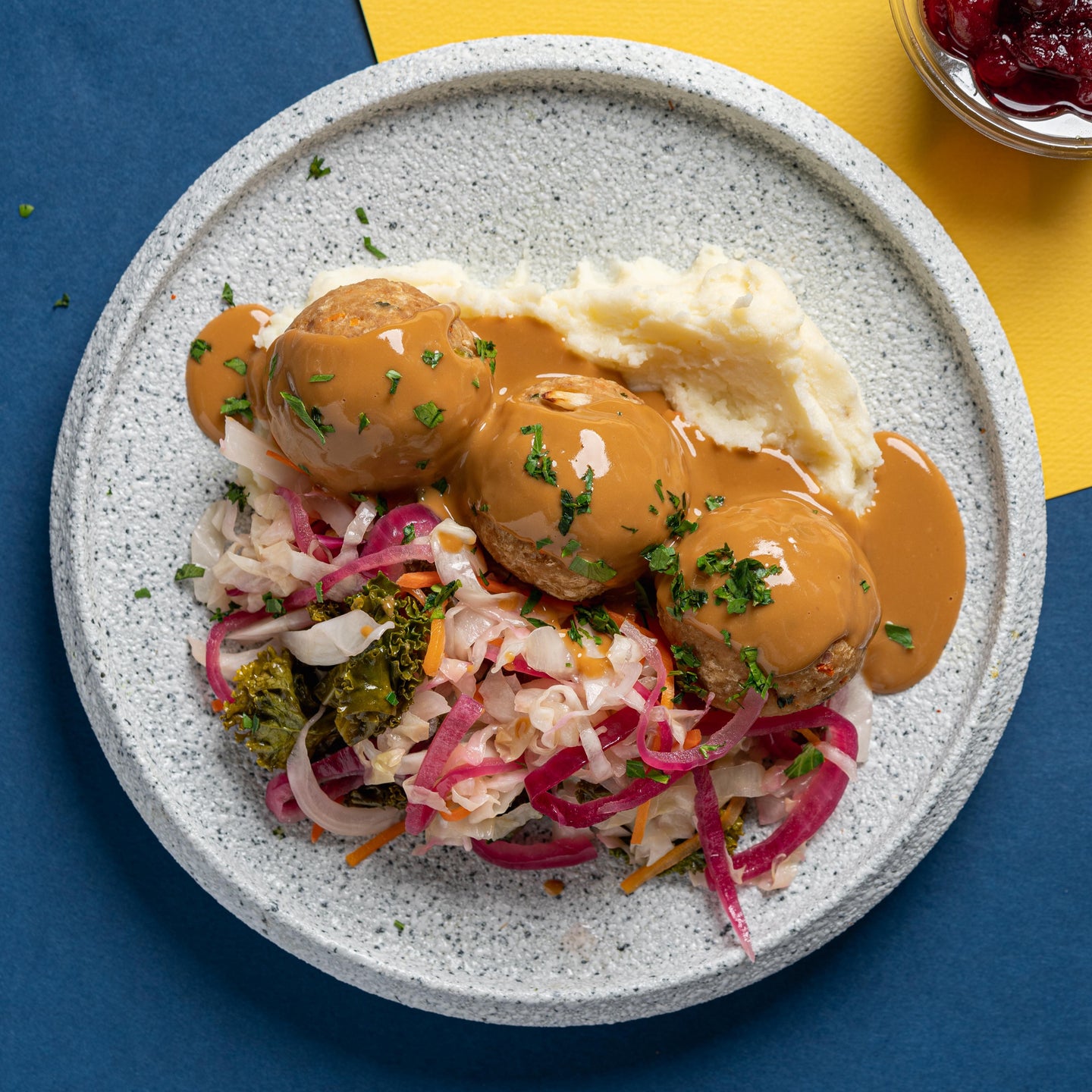 Swedish Plant-Based Chicken Meatballs with Braised Cabbage, Baby Kai Lan, Cranberry Compote & Mashed Potatoes